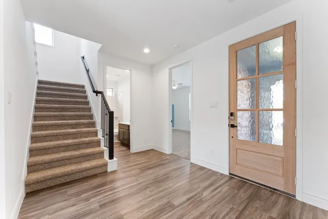 a view of wooden floor and windows in a room