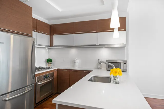 a kitchen with stainless steel appliances a sink and a refrigerator