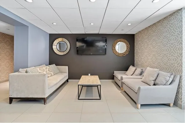 a living room with a couch and a wall painting