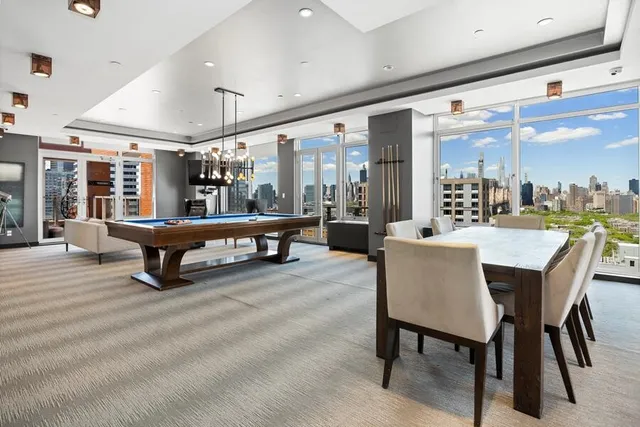 a living room with lots of furniture and a large window