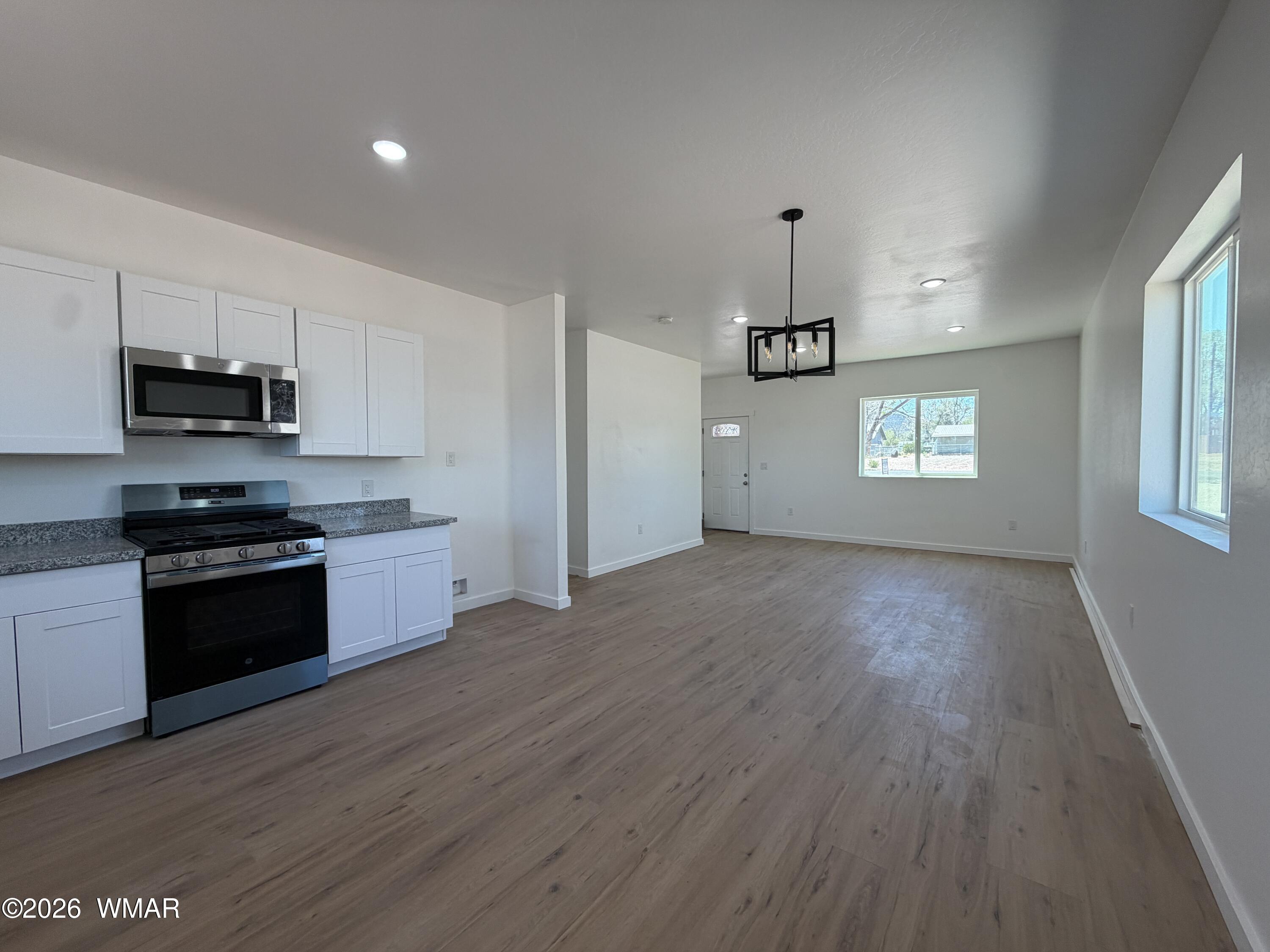 731 Tori Circle Springerville, AZ 85938 - Photo 6 of 19 a kitchen with granite countertop a stove a sink and a refrigerator