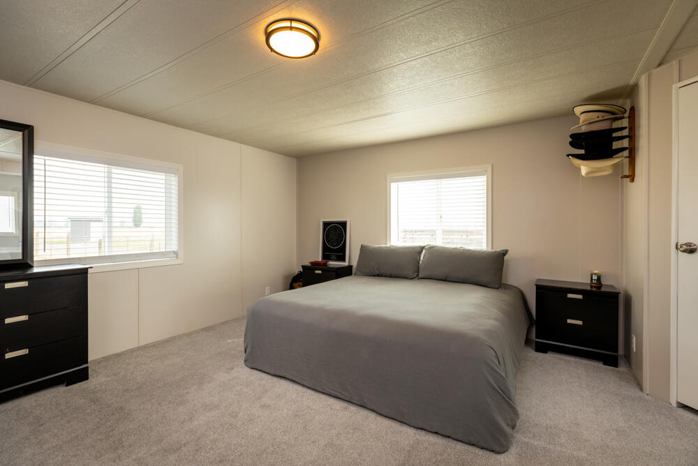 8757 Reeder Road Klamath Falls, OR 97603 - Photo 33 of 34 a bedroom with a bed and a flat tv screen on a dresser
