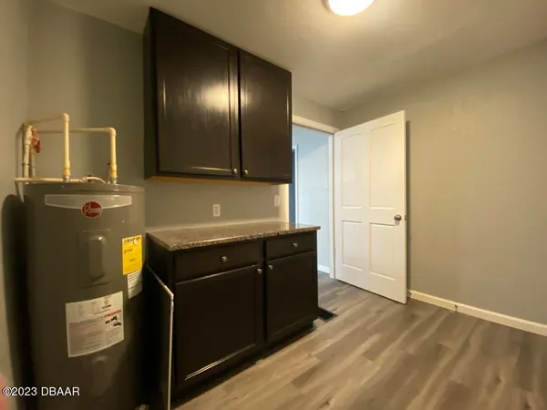 a kitchen with granite countertop a refrigerator and a stove