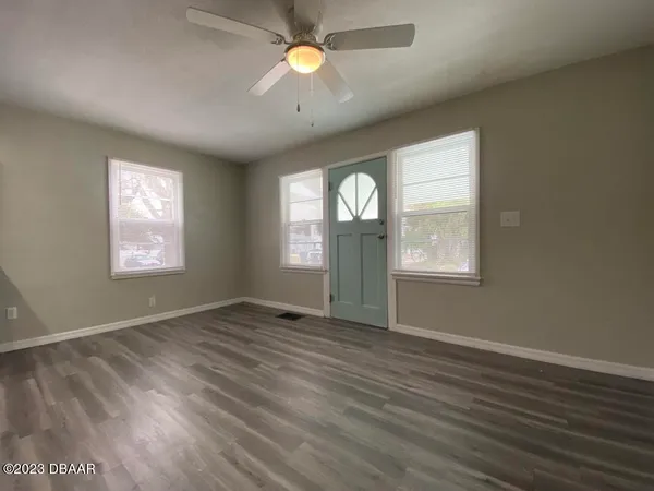 wooden floor in an empty room with a window