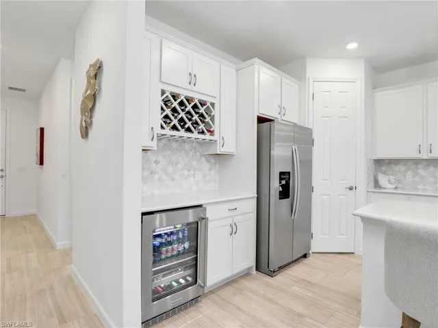 a kitchen with stainless steel appliances a refrigerator sink and cabinets