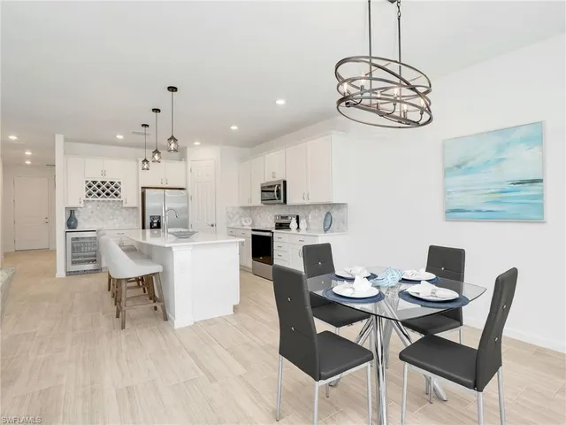 a view of a dining room with furniture wooden floor and chandelier