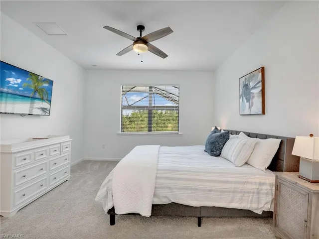 a bedroom with a bed and a painting on the wall