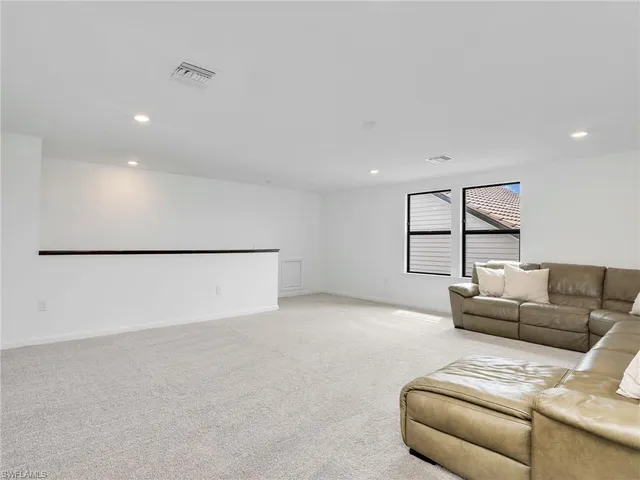 a living room with furniture a couch and a window