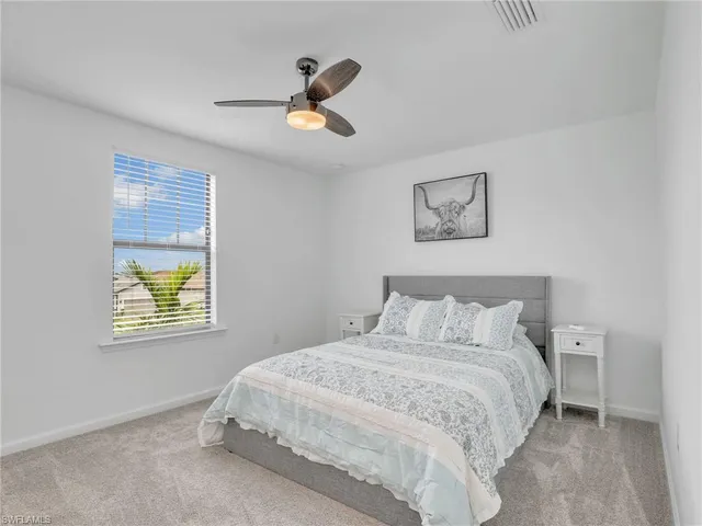 a bedroom with a bed and a painting