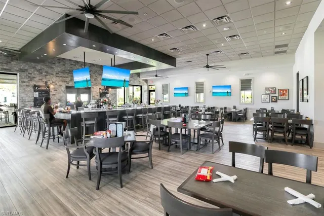 a room with lots of furniture and view of a dining room