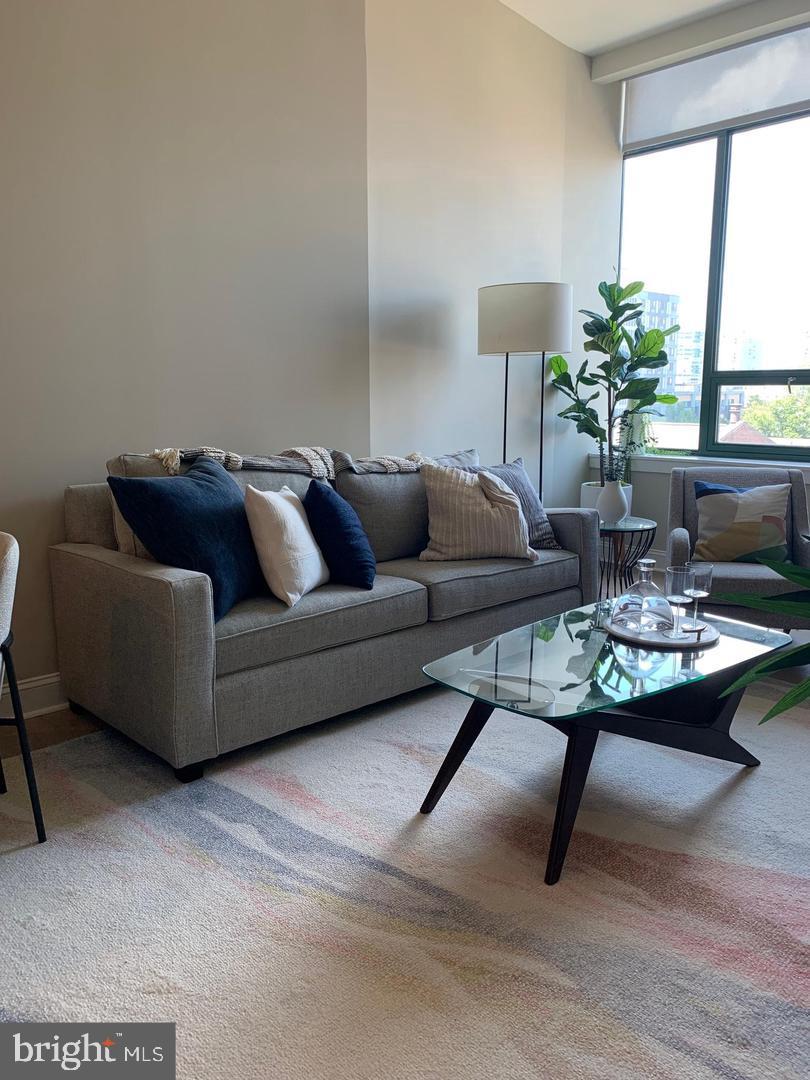 2130 Arch Street, Unit 103 Philadelphia, PA 19103 - Photo 6 of 25 a living room with furniture and a table
