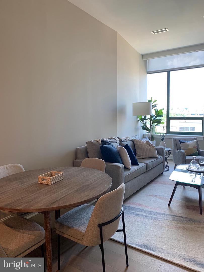 2130 Arch Street, Unit 103 Philadelphia, PA 19103 - Photo 7 of 25 a living room with furniture and a table