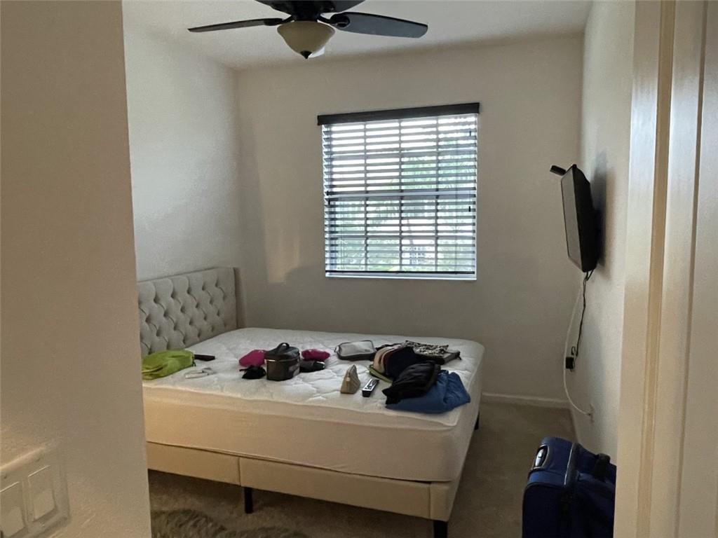 724 Southwest 2nd Way Pompano Beach, FL 33060 - Photo 9 of 13 a bedroom with a bed and a window