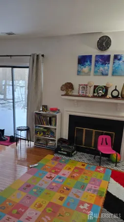 a living room with fireplace furniture and a flat screen tv