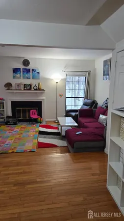 a living room with furniture flat screen tv and a fireplace