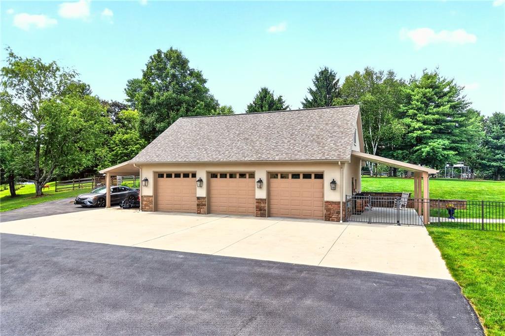 486 Settler Road Ligonier, PA 15658 - Photo 46 of 49 Is this your Dream Garage? Built in 2022, this 40x30, with three oversized Garage Bays, a carport on each side, radiant heated floors, Epoxy non slip flrs, 6 windows, a FULL BATH and an unfinished loft. Wired for a hot-tub.