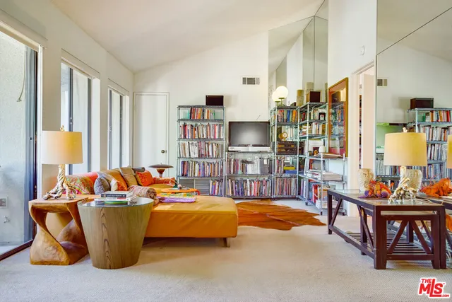 a living room filled with furniture and a table
