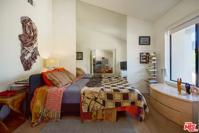 a bedroom with bed and a window