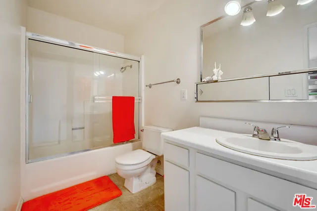 a bathroom with a toilet sink and shower