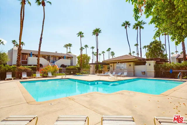 a view of a swimming pool with a yard