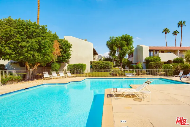 a view of a swimming pool with a yard