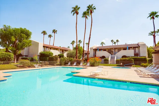 a view of a house with swimming pool and a small yard