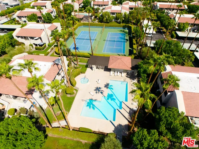 an aerial view of a house with a yard and garden