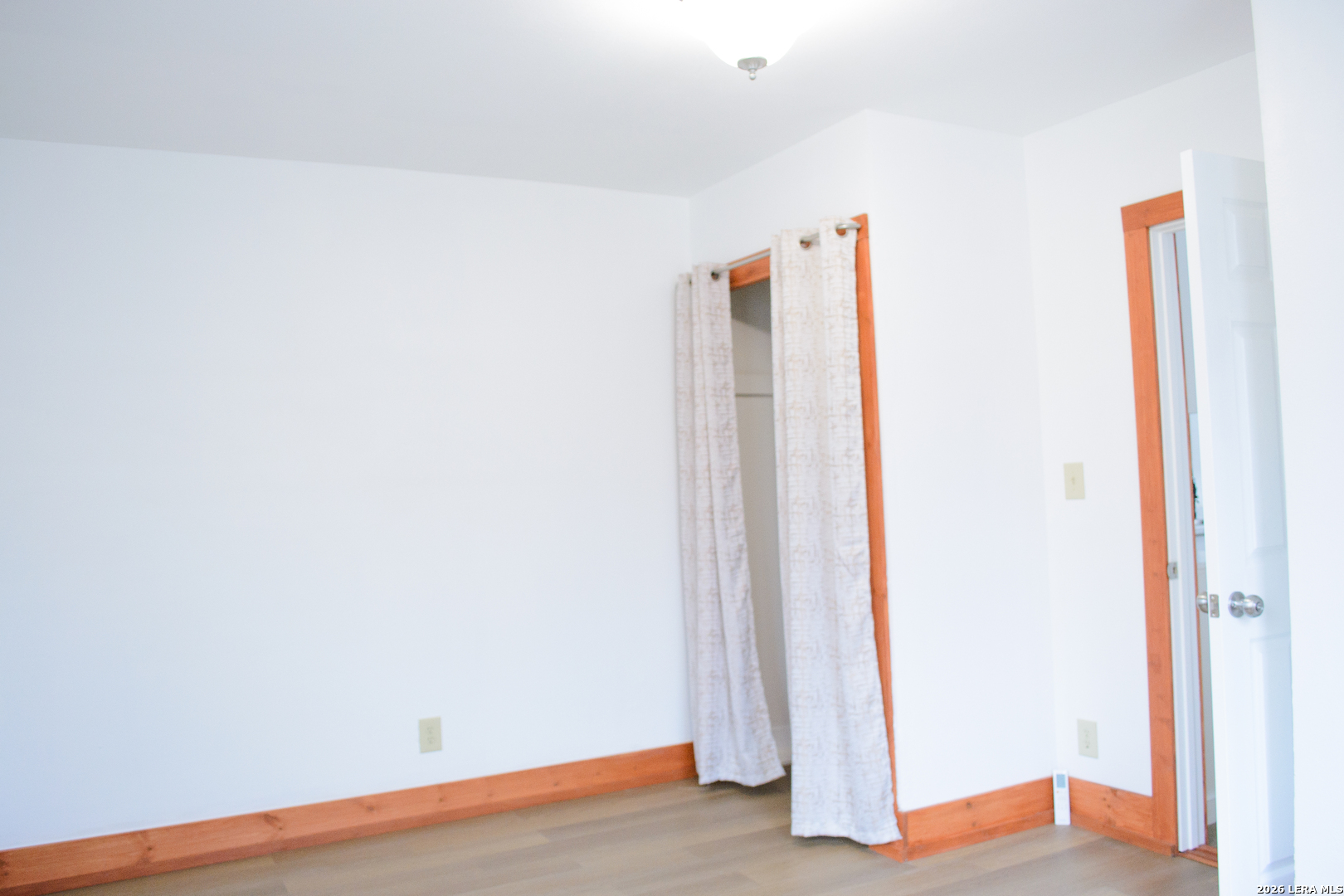 1406 Castroville Road San Antonio, TX 78237 - Photo 14 of 19 an empty room with wooden floor and a window