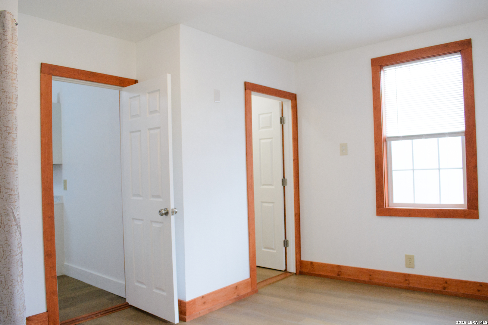 1406 Castroville Road San Antonio, TX 78237 - Photo 15 of 19 a view of an empty room with wooden floor and a window