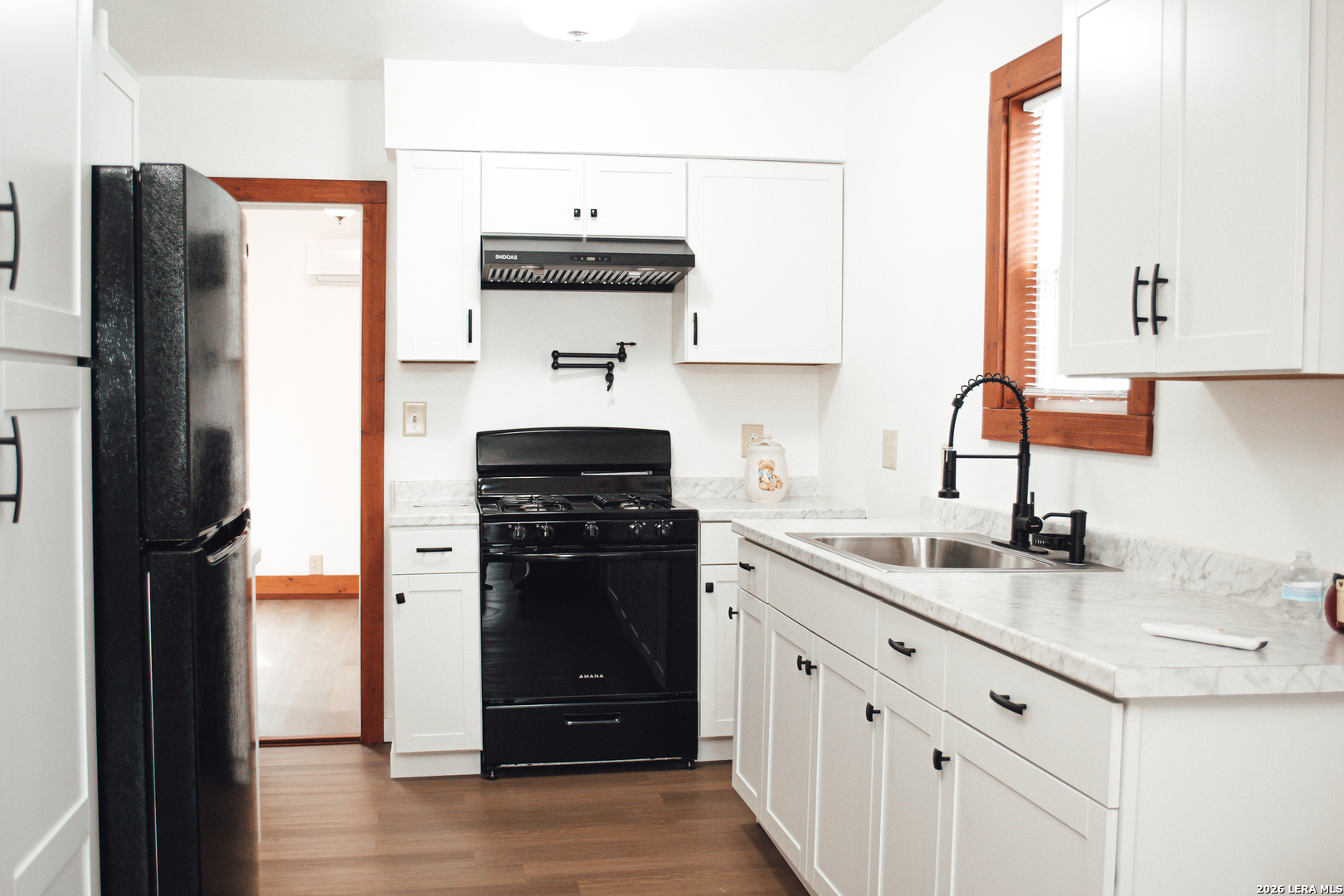 1406 Castroville Road San Antonio, TX 78237 - Photo 9 of 19 a kitchen with a sink and a refrigerator