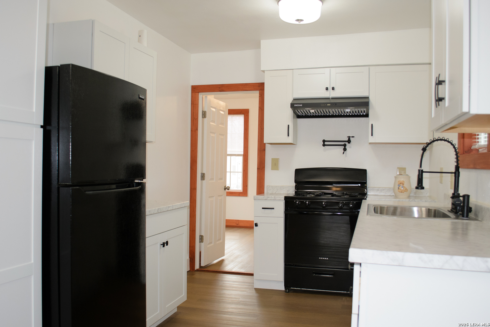 1406 Castroville Road San Antonio, TX 78237 - Photo 10 of 19 a kitchen with a refrigerator and a stove