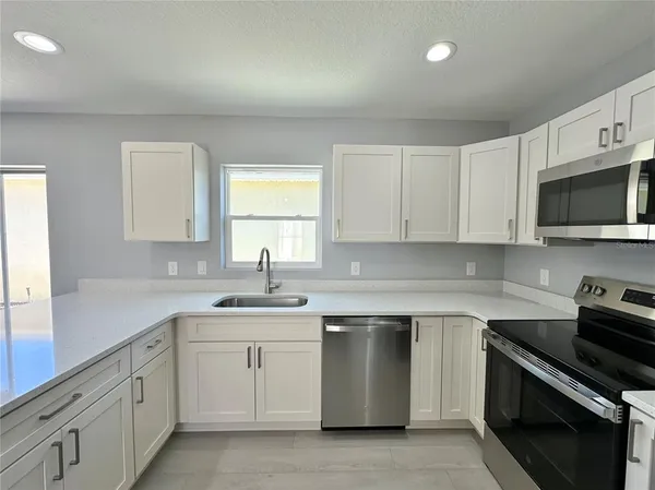 a kitchen with granite countertop white cabinets and a granite counter tops
