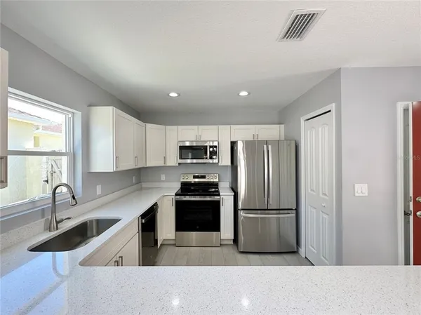 a kitchen with a refrigerator and a sink