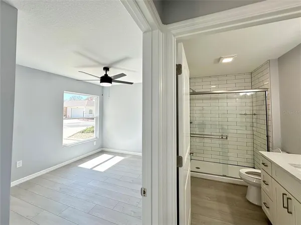 a view of room with wooden floor and windows