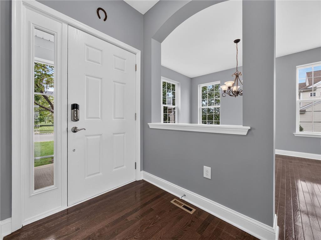 2765 Farmstead Road Easton, PA 18040 - Photo 6 of 50 Rich hardwood flooring guides you from the entry to a well-lit living area, framed by classic window architecture.