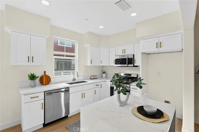 a kitchen with a sink a stove and cabinets