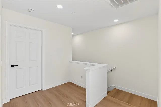 a bedroom with a bed and a night stand