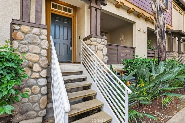 a view of a balcony with chairs and potted plants