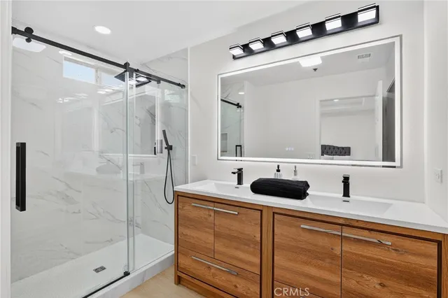 a bathroom that has a glass shower door
