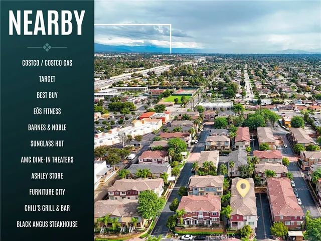 a view of a backyard with plants and outdoor seating