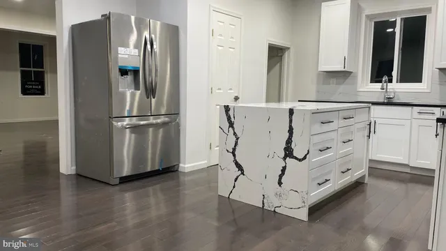 a kitchen with stainless steel appliances a refrigerator sink and cabinets
