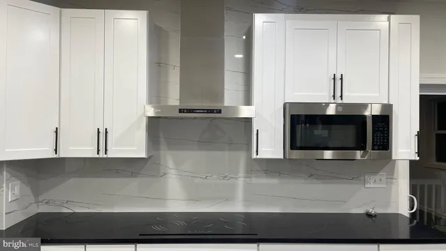 a view of a living room with a fireplace and cabinets