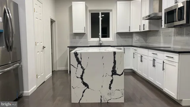 a kitchen with a refrigerator and a sink