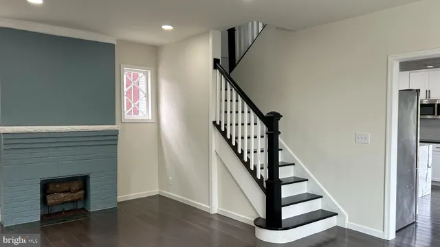 a view of entryway with wooden floor and stairs