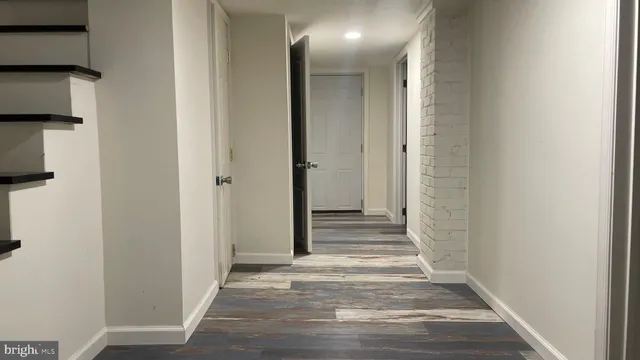 a view of a hallway with wooden floor