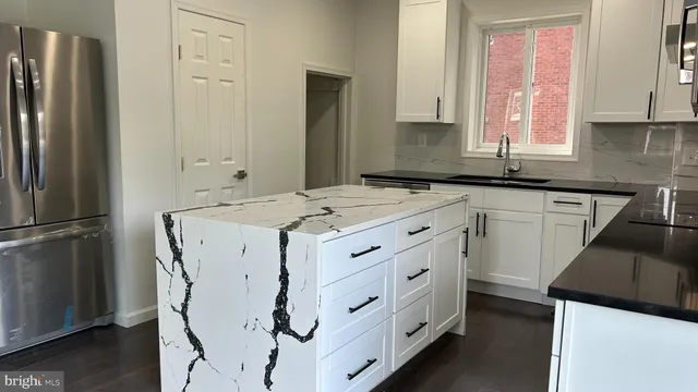 a kitchen with a stove a sink and a refrigerator
