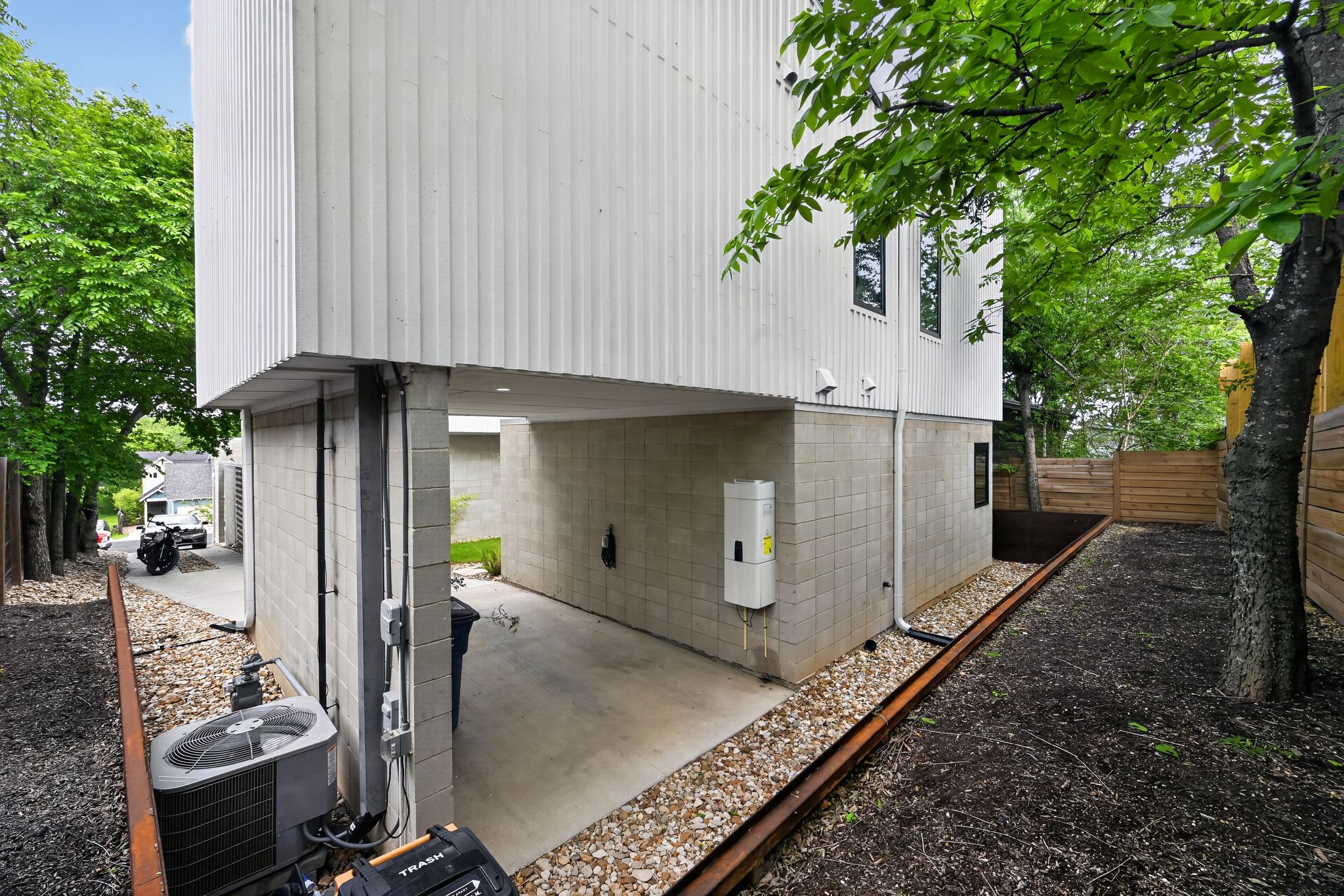 1206 Luna Street, Unit 2 Austin, TX 78721 - Photo 29 of 30 The property features a partial concrete driveway and a gravel pathway along the exterior