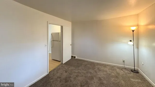 an empty room with wooden floor and closet