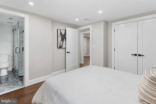 a bedroom with a bed and a shower