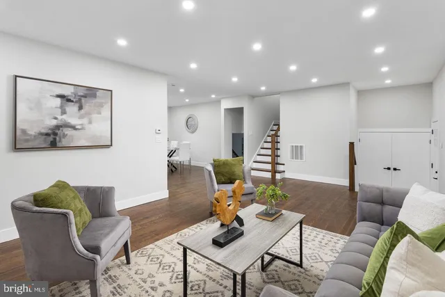 a living room with furniture and wooden floor